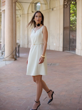 a lady in a worsted wool mini vest dress with high heels